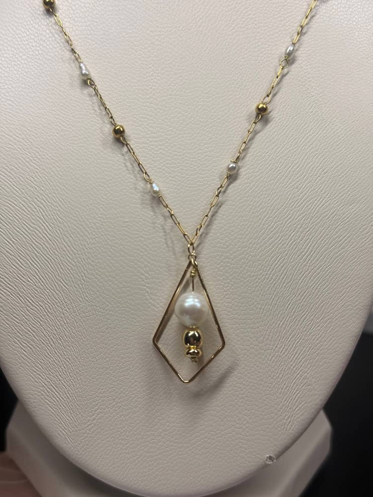 Necklace with fresh water pearls and gold accents.